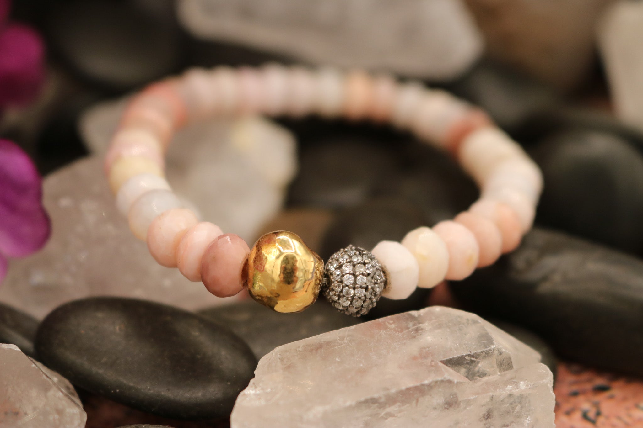 Calming Pink Opal Stone Bracelet Adorned with a Single Gold Bead and another Bead Embellished with Small Rhinestones.