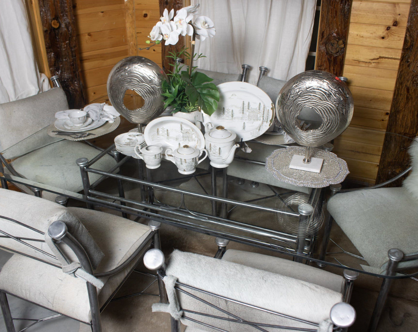 Classic Raw Metal Table with Glass Tabletop and Six Chairs with Cowhide Cushions
