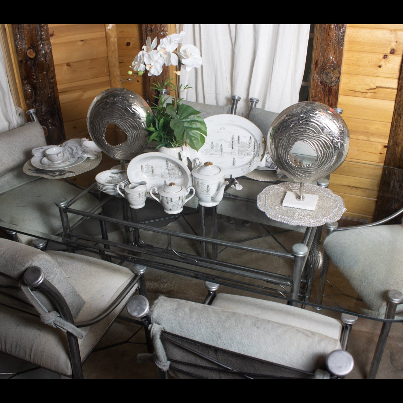 Classic Raw Metal Table with Glass Tabletop and Six Chairs with Cowhide Cushions